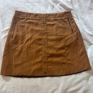Mini suede skirt with button down the front and zipper pockets